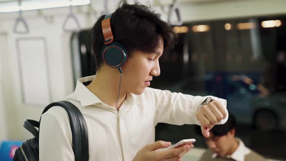 Businessman Using Mobile Phone on Public Train