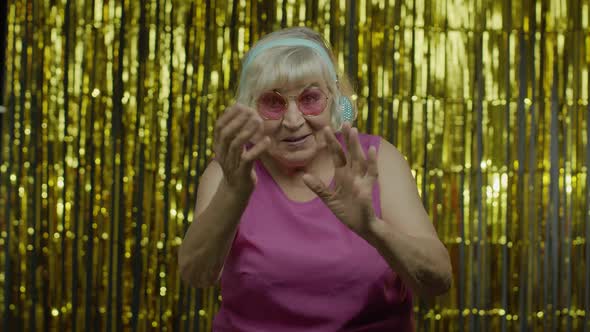 Friendly Senior Old Woman Waving Hands Looking at Camera with Toothy Smile, Saying Hi, Greeting