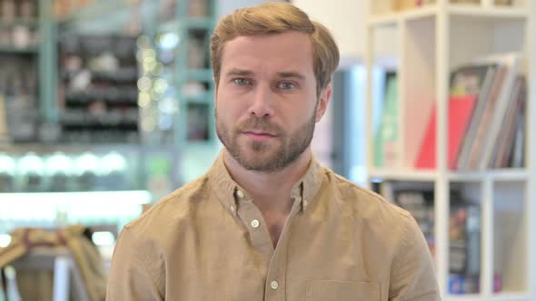 Portrait of No Sign By Young Man Shaking Head 