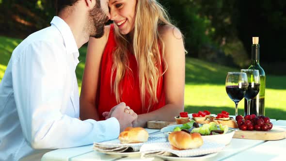 Couple romancing in outdoor restaurant