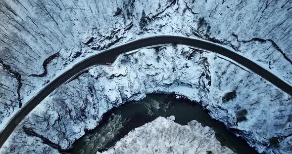 Directly Above View of Snowy Mountain Road and River