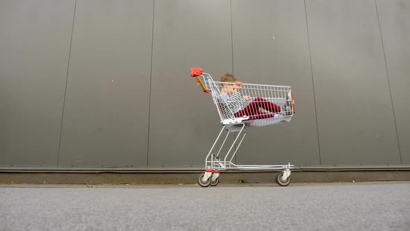 Black Friday Backgroung. Big Sales Concept. Shopping Background. Shopping Cart with Child Inside