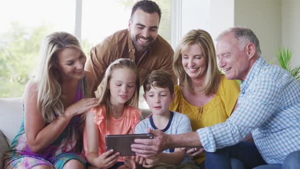 Portrait of six members of a multi-generation Caucasian family spending time at home together