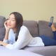 Asian woman sit on sofa and relax - VideoHive Item for Sale