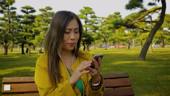 Japanese woman using her smartphone in Tokyo Japan