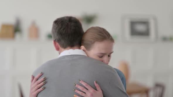 Couple Standing and Hugging at Home