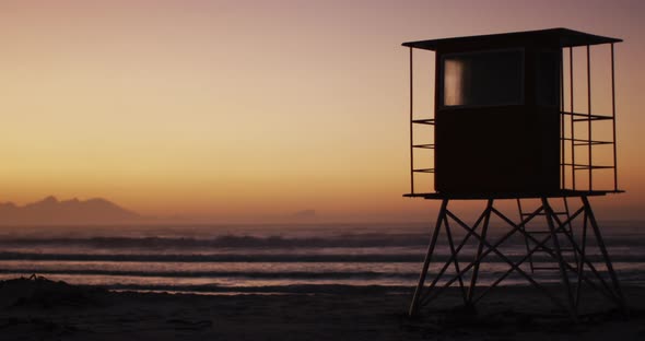 Sea with waves and blue sky and lifeguard tower on beach