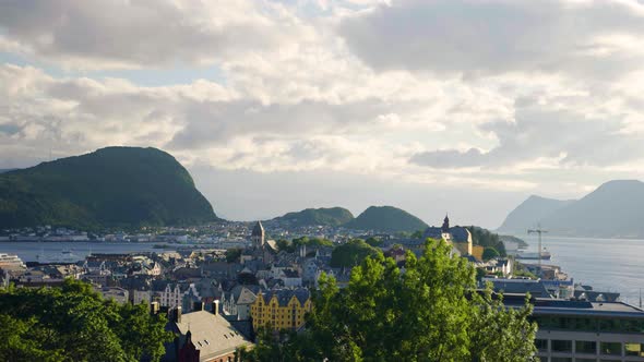 Beautiful aerial shot of Alesund City with blue Fjord and mountains in background in Norway