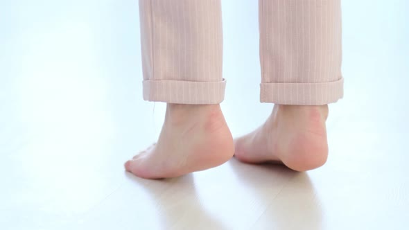Side Close Up View of Unrecognizable Woman Feet Legs Barefoot Girl Standing Indoors Inside of Modern