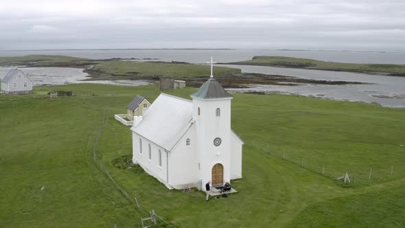 Aerial View Of Flatey Church In Greenery Landscape At Flatey Island In Breidafjordur