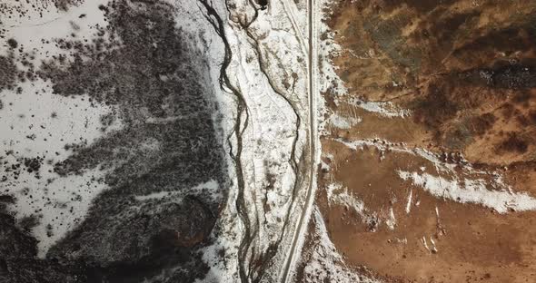 aerial overhead shot on a snowy valley and the river