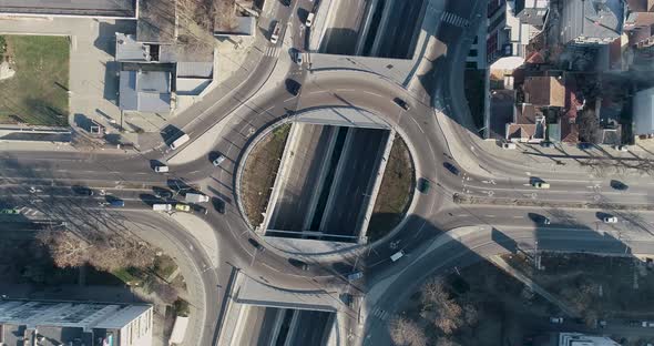 Top down view round road junction in the center. Circle road on two levels.  Street traffic