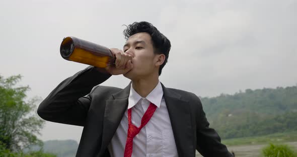 Depressed Businessman Walking And Drink Alcohol