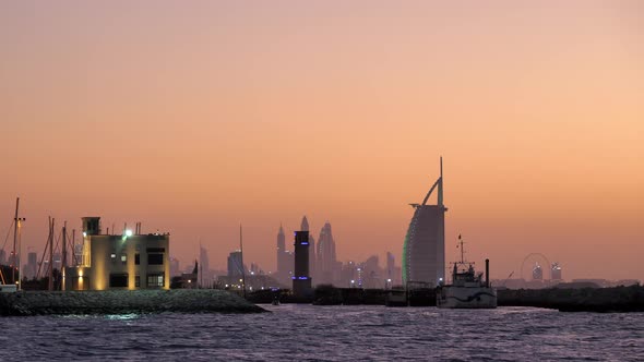 Dubai Marine and Burj Al Arab Skyline after Sunset, Orange Glow Sky.