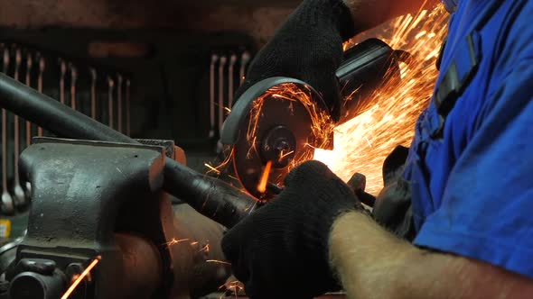 Craftsman Working With a Circular Saw, Sparks Fly From the Hot Metal. Men's Hard Work