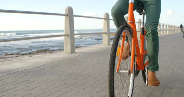 Man cycling on the beach 4k