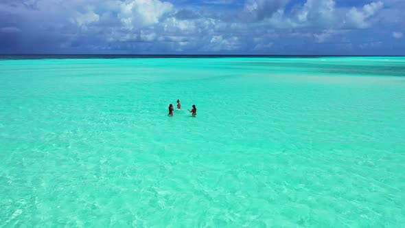 Sexy happy ladies on holiday by the sea on beach on summer white sand and blue background 4K