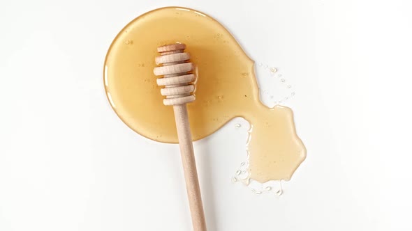 Rotation of the Composition with Fresh Honey on a White Background Top View