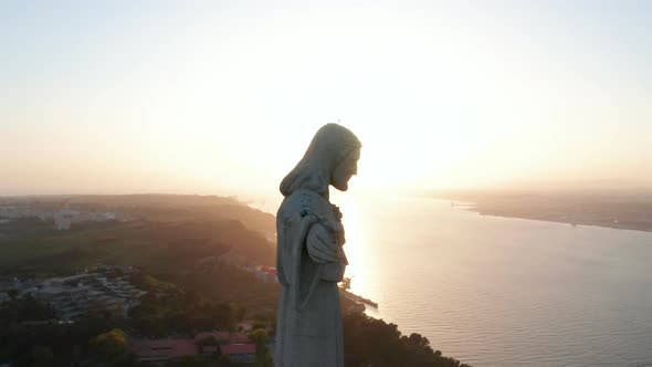 Close Up Aerial Orbit of Sanctuary of Christ the King Statue on the Hill with Reveal of Ponte 25 De