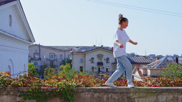 Girl Performing Modern Dances on Retaining Wall