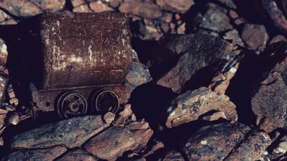 Abandoned Rusty Mine Cart on Rocks alt