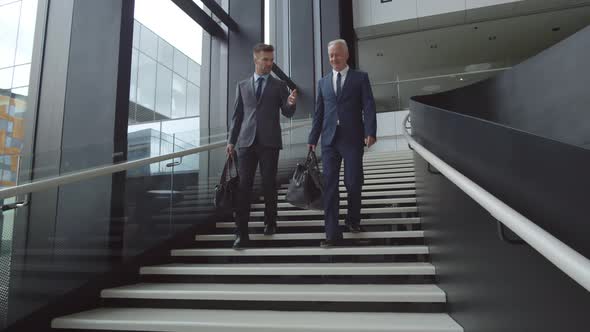 Two Men Wearing Smart Suits in Airport