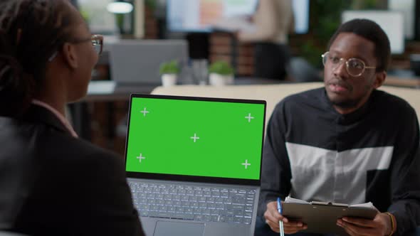 African American Man and Woman Working Together with Green Screen