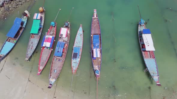 Top View of Wooden Fishing Boats Anchored By the Sea Shore in Thailand. Aerial View