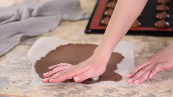 Woman Cutting Chocolate Shortcrust Dough Into Circles, Making Choux Buns with Craquelin