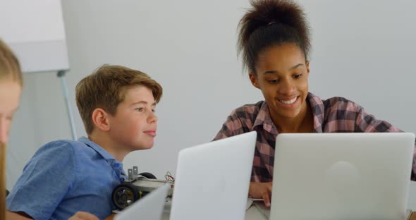 Kids using laptop in training institute 