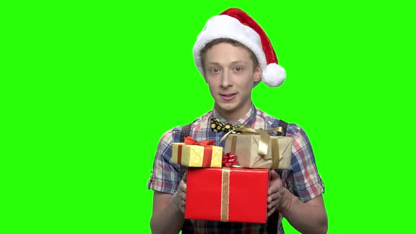 Young Teen Boy with Gift Boxes and Hat for Christmas