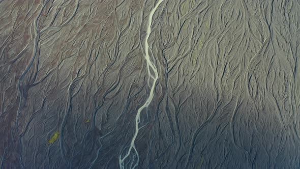 Drone Over Sunlit Landscape With Dry Riverbed Of Braided River