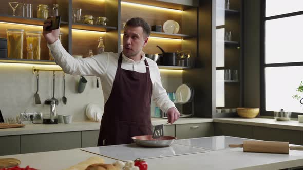 Man Chef Blogger Records Process of Frying Vegetables on Pan