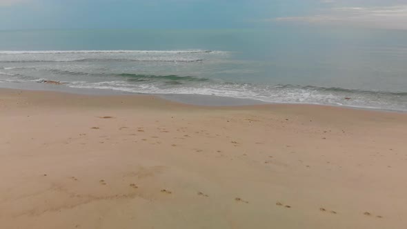 Waves lapping on beach in the Gulf of Thailand. Early morning in Khanom.