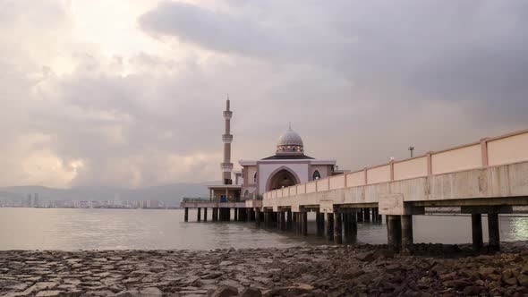 Timelapse day to night transition of floating mosque high tide to low tide.
