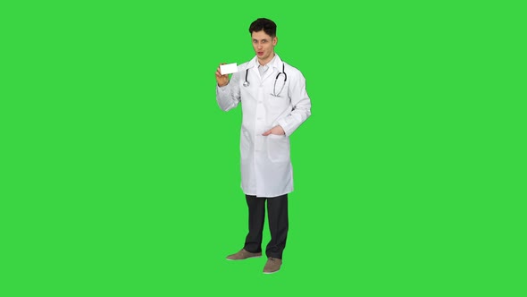 Medical Doctor Holding a Box of Pills Promoting Them and Dancing on a Green Screen, Chroma Key.