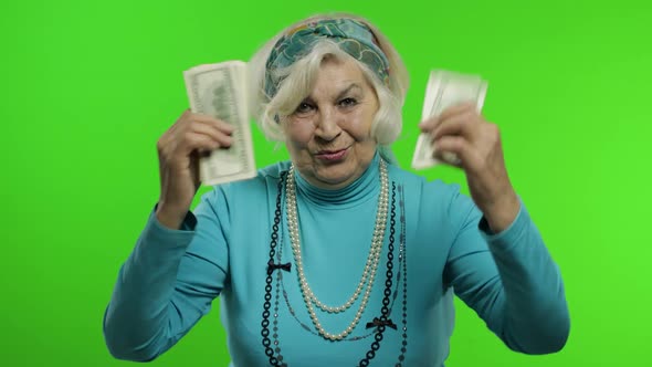 Elderly Grandmother. Caucasian Woman with Money Banknotes Celebrates, Smiling