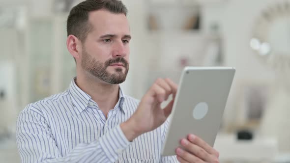 Portrait of Ambitious Young Man Using Digital Tablet