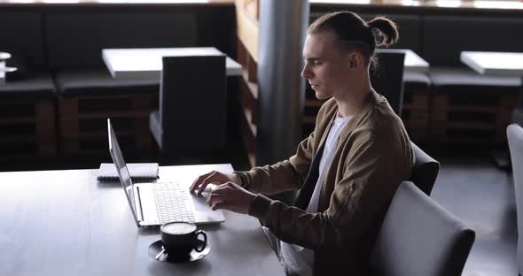 Freelancer Man Working By Laptop PC in a Cafe