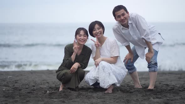 Men and women taking pictures with self-timer