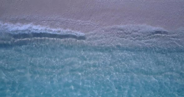 Wide angle aerial tourism shot of a summer white paradise sand beach and blue ocean background in be