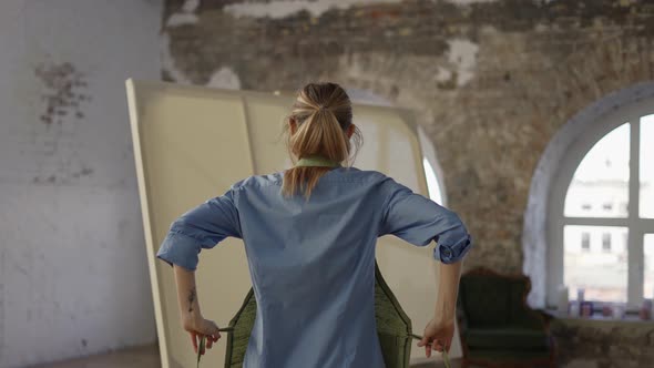 Unrecognizable Woman Put on Apron to Start Painting in Workshop