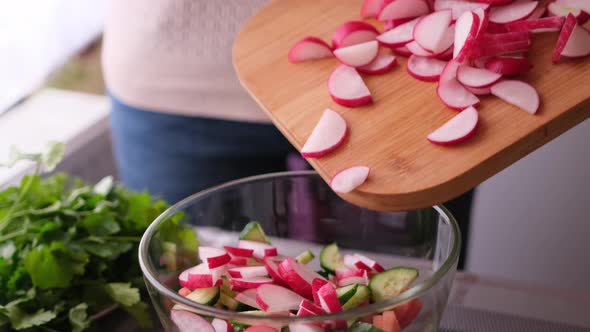 Closeup of Woman Slicing Radish on Wooden Cutting Board  Preparing Ingredient for Meal