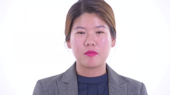 Face of Happy Young Asian Businesswoman Talking