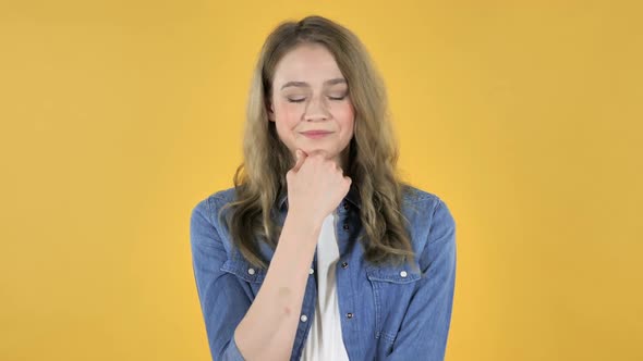 Thinking Young Pretty Girl on Yellow Background Brainstorming