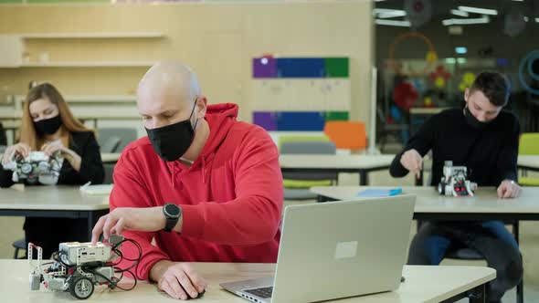 Robotics Teacher Who Teaches Course for His Students Using a Computer