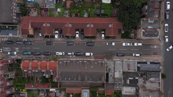 Aerial Birds Eye Overhead Top Down Panning View of Car Driving in Narrow Town Streets and Crossroads