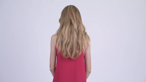 Rear View of Young Blonde Woman Thinking and Waiting