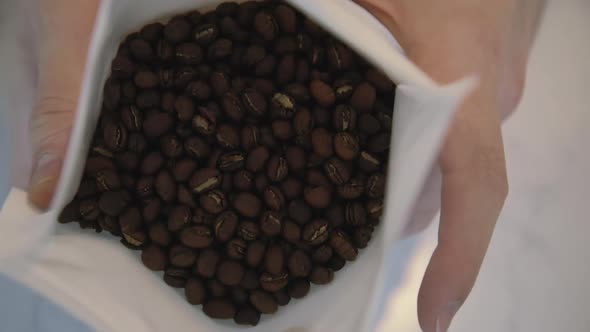 The Barista Arranges and Pours the Finished Coffee From the Filter Into White Cups