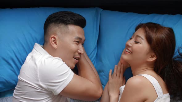 Asian Couple Lying in Bed